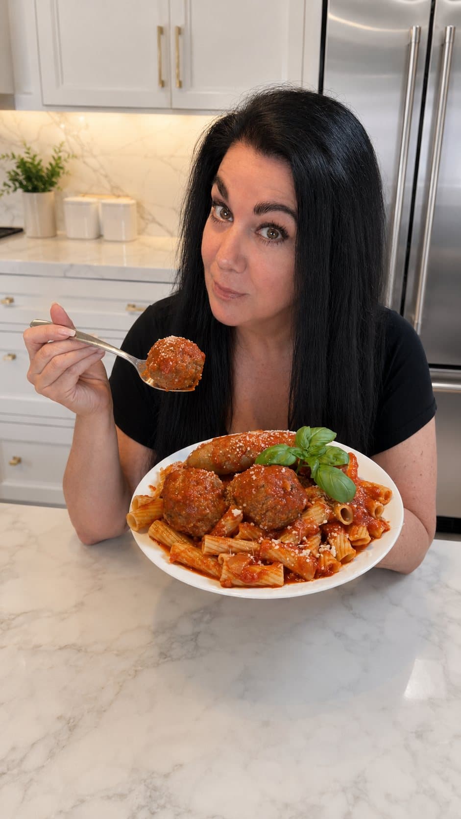 A plate of her own meatballs, in her own kitchen